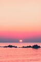 Pink Sun Sets Over The Horizon to the Sea Canvas Print